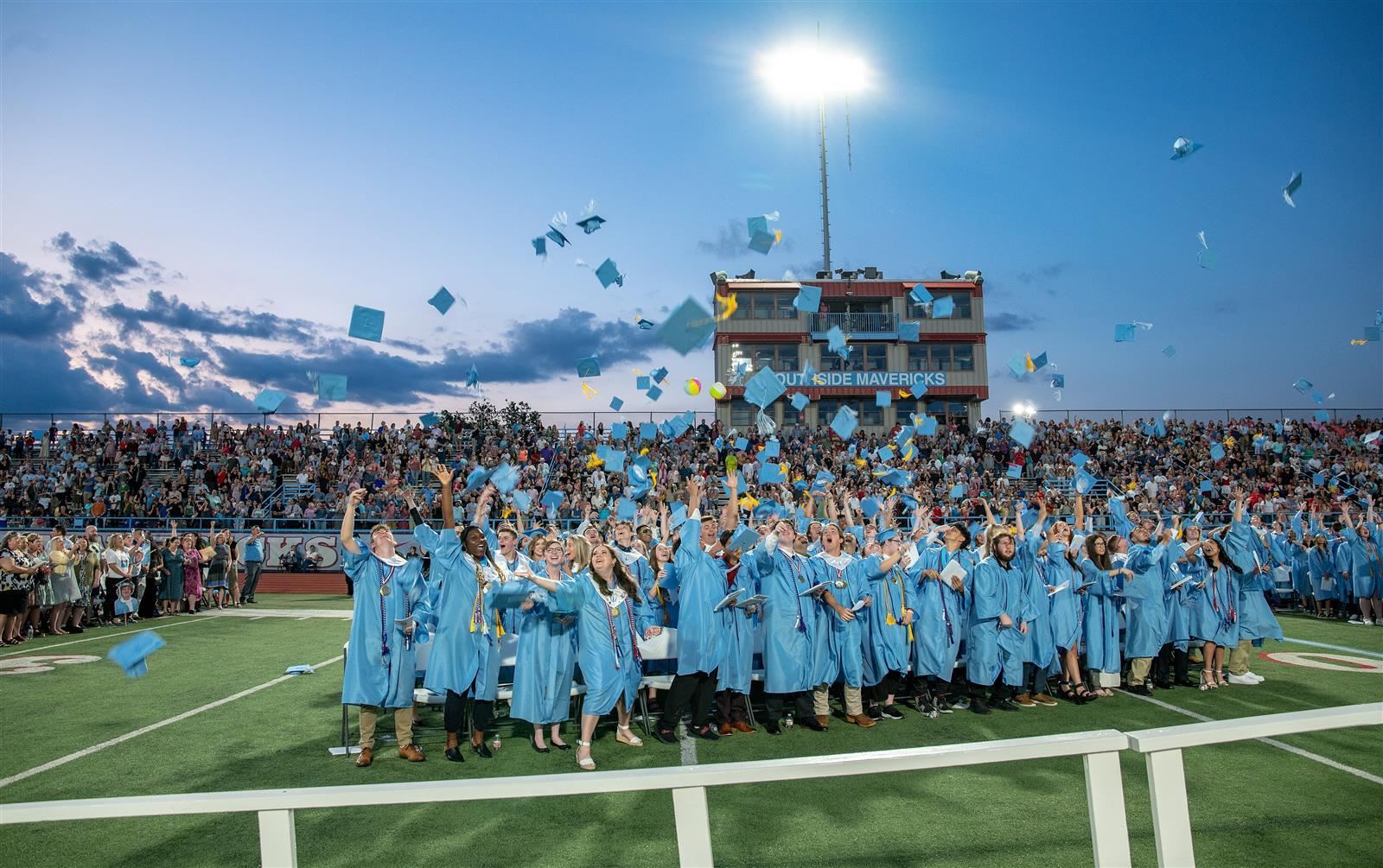 Seniors tossing caps